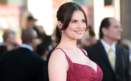 HD PC desktop wallpaper featuring English actress and celebrity Hayley Atwell smiling in a red dress at a formal event.