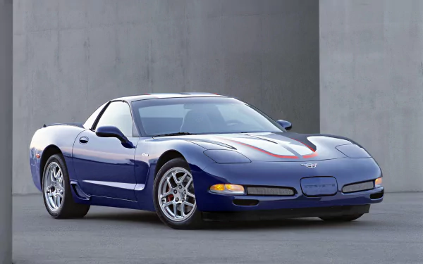 HD PC desktop wallpaper of a blue Chevrolet Corvette Z06 sports vehicle parked against a concrete wall, high-resolution automotive background.