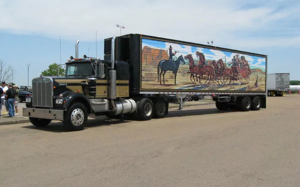 HD PC desktop wallpaper showing a black Peterbilt semi with a western stagecoach mural on its trailer, referencing the movie Smokey and the Bandit.