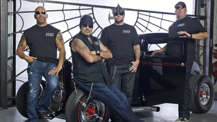 HD desktop wallpaper featuring the cast of the TV show Counting Cars posing with a custom vintage hot rod in a garage setting.