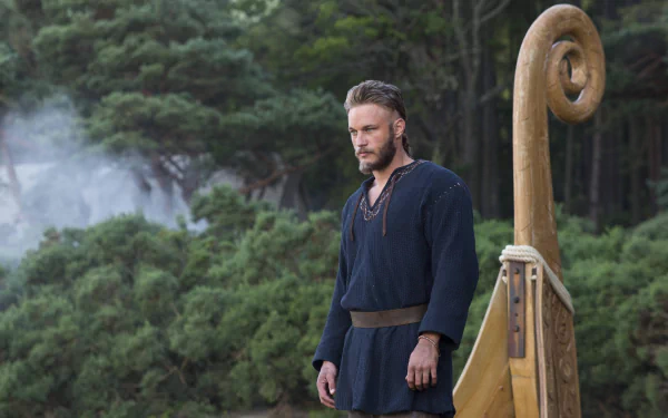 Ragnar Lothbrok from Vikings (2013) stands beside a Viking ship amidst a forest backdrop in this 4K Ultra HD PC desktop wallpaper and background.