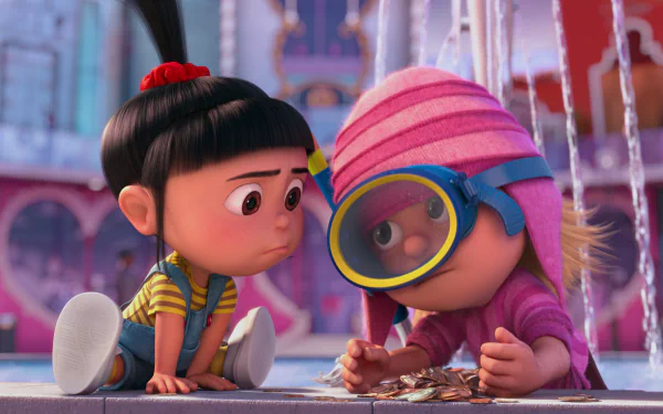 Two animated characters from Despicable Me 2, Edith and Agnes, are crouched together, examining coins while surrounded by a vibrant, colorful backdrop.