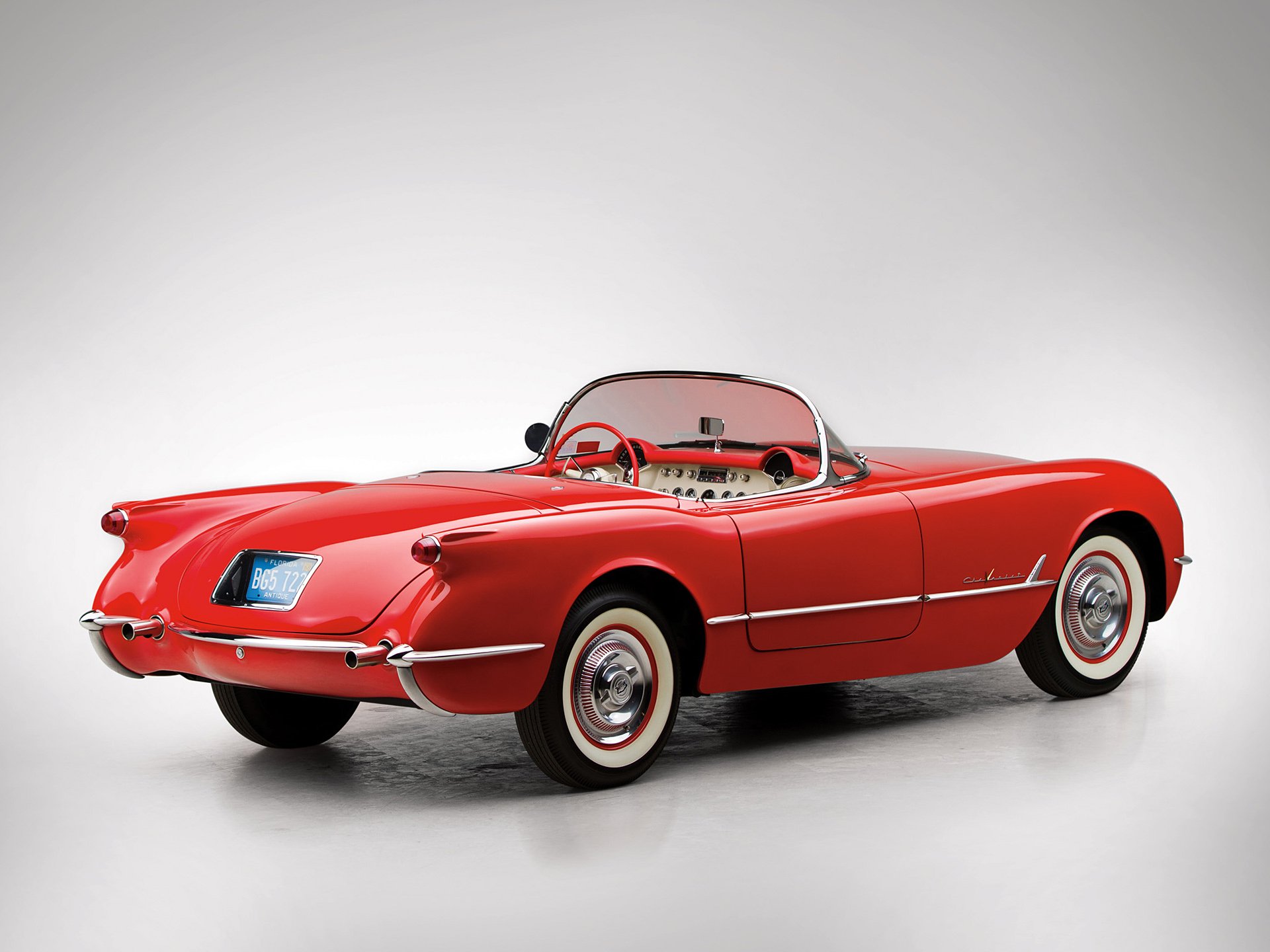 Red Chevrolet Corvette (C1) classic vehicle roadster on a neutral backdrop — HD PC desktop wallpaper and background.