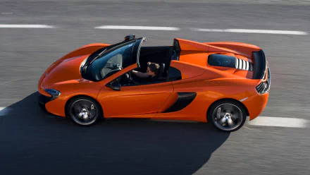 Orange McLaren 650S Spider supercar captured in motion on a racetrack, showcased as an HD PC desktop wallpaper and background.