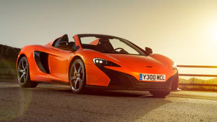 HD PC desktop wallpaper of an orange McLaren 650S Spider supercar parked at sunset, low-angle view of the convertible McLaren 650S sports car.