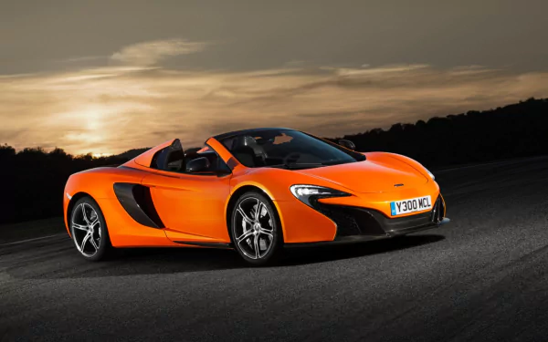 Orange McLaren 650S Spider supercar on asphalt at sunset, sporty orange convertible McLaren vehicle desktop wallpaper.
