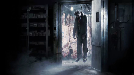 A high-definition wallpaper featuring a scene from the video game Mafia II, depicting a man hanging in a dimly lit meat locker with carcasses in the background, creating a dark and intense atmosphere.