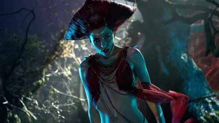 Blue-green lit vampire woman in ornate headdress and draped chains in a moonlit forest — cinematic still from the movie Lesbian Vampire Killers, HD PC desktop wallpaper/background.