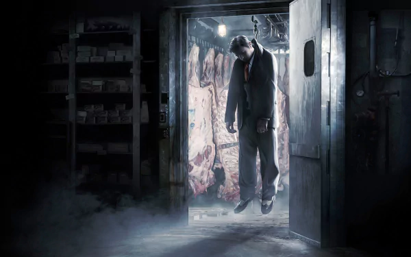 A high-definition wallpaper featuring a scene from the video game Mafia II, depicting a man hanging in a dimly lit meat locker with carcasses in the background, creating a dark and intense atmosphere.