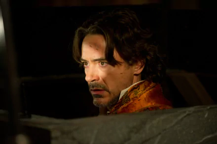 Robert Downey Jr. stars as Sherlock Holmes in Sherlock Holmes: A Game of Shadows, captured in a dramatic moment in this stunning 4K Ultra HD wallpaper.