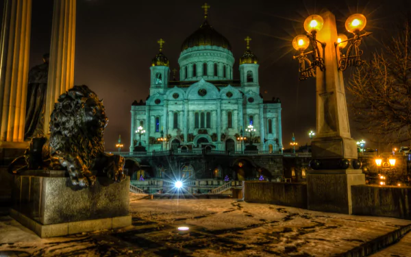 Religious Cathedral of Christ the Saviour at night, glowing domes and lion statues under streetlamps — HD PC desktop wallpaper/background.