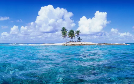 HD desktop wallpaper showing a small tropical island with palm trees surrounded by clear blue ocean under a bright sky with white clouds.