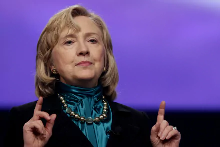 HD wallpaper featuring Hillary Rodham Clinton, showcasing her speaking passionately with a purple background, emphasizing her role as a prominent political figure.