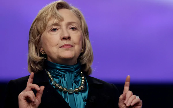 HD wallpaper featuring Hillary Rodham Clinton, showcasing her speaking passionately with a purple background, emphasizing her role as a prominent political figure.