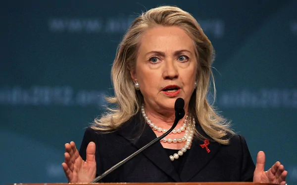 HD desktop wallpaper featuring Hillary Rodham Clinton speaking at a podium, suitable as a background.