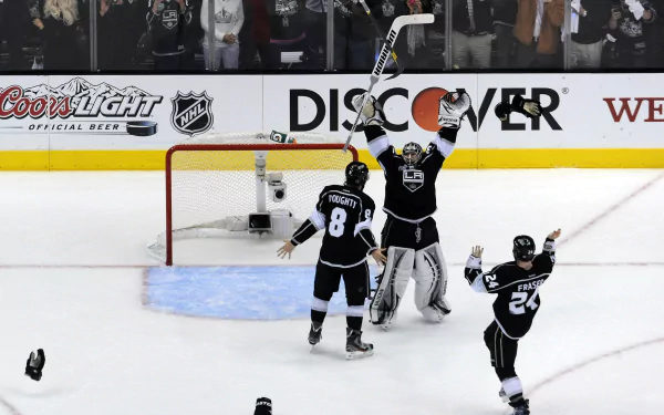 HD desktop wallpaper featuring Los Angeles Kings hockey players celebrating a goal on the ice.