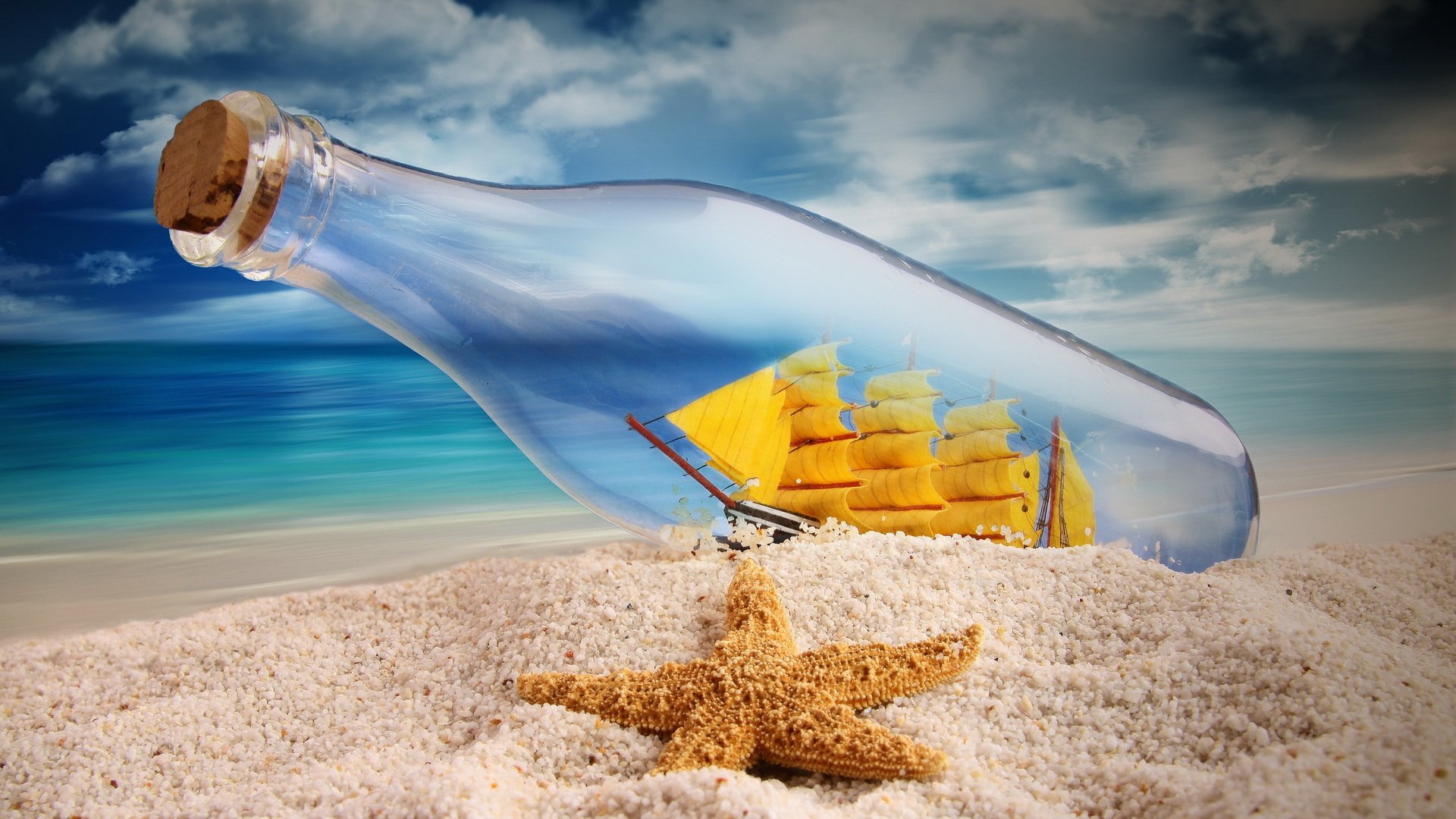 HD desktop wallpaper featuring a man-made ship in a bottle resting on sandy beach with a starfish, set against a bright ocean and cloudy sky background.