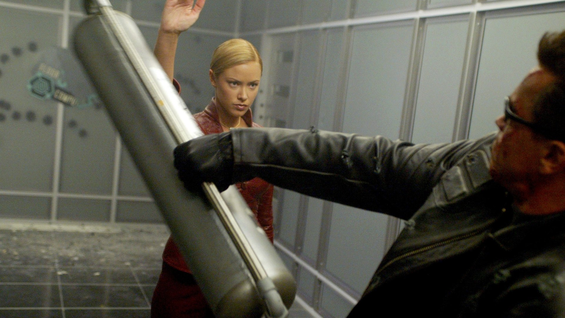 A dynamic scene from Terminator 3: Rise of the Machines, featuring an intense confrontation between two characters in a futuristic setting, captured as an HD PC desktop wallpaper.