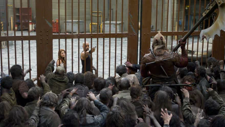 HD PC desktop wallpaper featuring a scene from the movie Resident Evil: Afterlife with characters confronting a crowd of zombies behind metal bars.