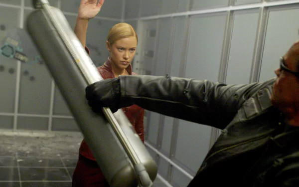 A dynamic scene from Terminator 3: Rise of the Machines, featuring an intense confrontation between two characters in a futuristic setting, captured as an HD PC desktop wallpaper.