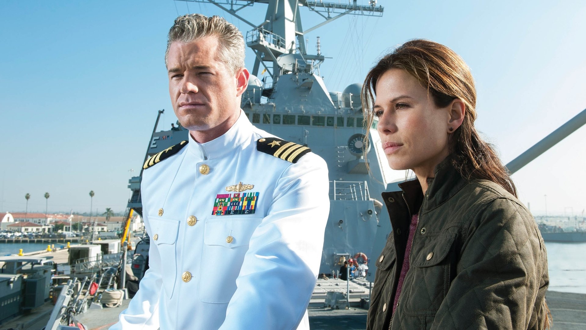 2K Quad HD PC desktop wallpaper from the TV show The Last Ship: a naval commander in white uniform and a woman in a dark jacket stand on a warship deck under a clear sky.