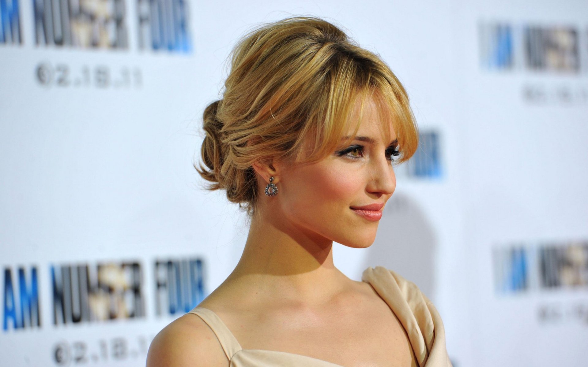 HD PC desktop wallpaper featuring American actress and celebrity Dianna Agron with an elegant updo and neutral-toned attire at a red carpet event.