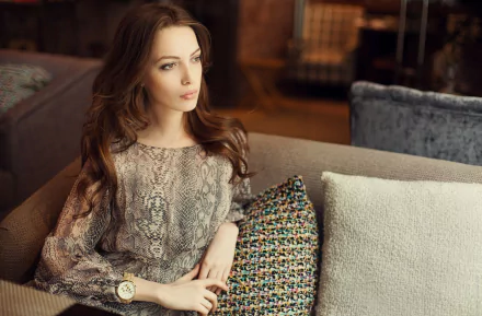 HD PC desktop wallpaper featuring model Bianca Dragusanu seated indoors, wearing a patterned blouse and a watch, with a soft, warm-toned background.
