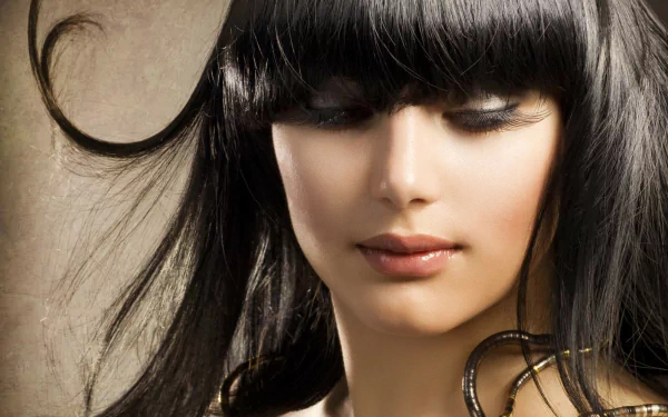 HD desktop wallpaper featuring a close-up portrait of a woman with dark hair and soft makeup, tagged with Judy Wilkins.