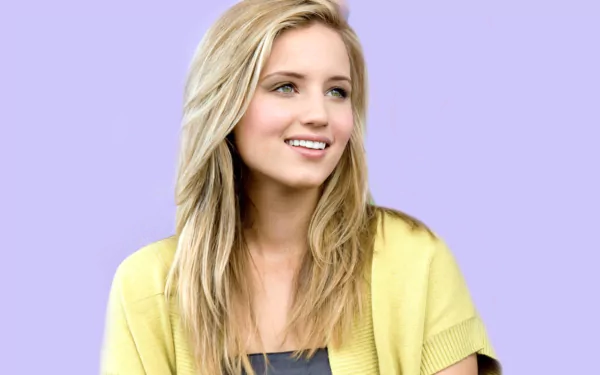 HD PC desktop wallpaper of a smiling American actress and celebrity with long blonde hair wearing a yellow top against a soft lavender background.