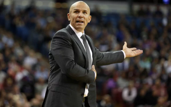 HD desktop wallpaper featuring a man in a suit coaching on a basketball court, expressing a strategy with an outstretched hand.