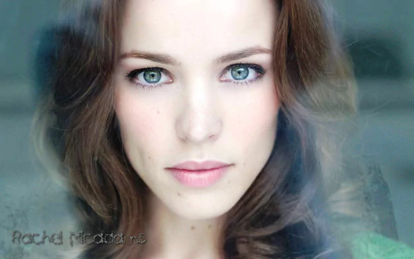 HD desktop wallpaper featuring a close-up of a woman with captivating blue eyes and a subtle smile.