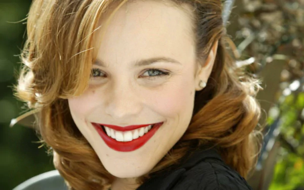 HD desktop wallpaper featuring a smiling woman with vibrant red lipstick, offering a cheerful background ambiance.