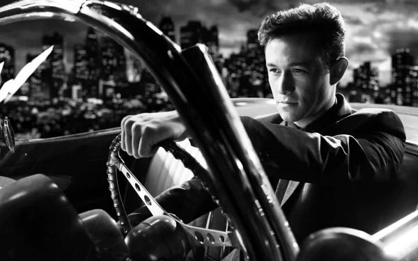 Black-and-white 5K Ultra HD PC desktop wallpaper: a suited man gripping a vintage steering wheel, city skyline behind him — promotional image for the movie Sin City: A Dame to Kill For.
