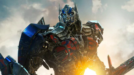 HD desktop wallpaper of Optimus Prime from Transformers: Age of Extinction, featuring the iconic leader poised heroically against a sunlit sky.