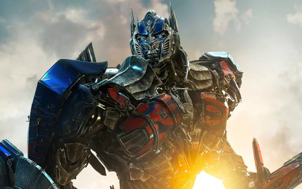 HD desktop wallpaper of Optimus Prime from Transformers: Age of Extinction, featuring the iconic leader poised heroically against a sunlit sky.