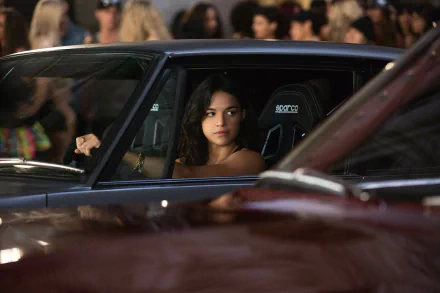 Michelle Rodriguez as Letty Ortiz is featured in this high-definition image from *Fast & Furious 6*, capturing her intense gaze from inside a sleek car.