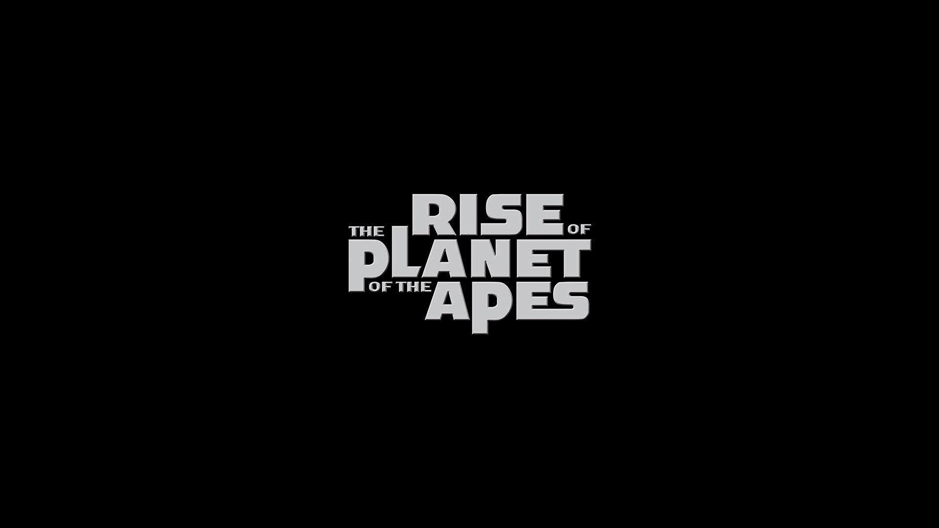 HD PC desktop wallpaper featuring the bold white title text of the movie Rise of the Planet of the Apes on a black background.