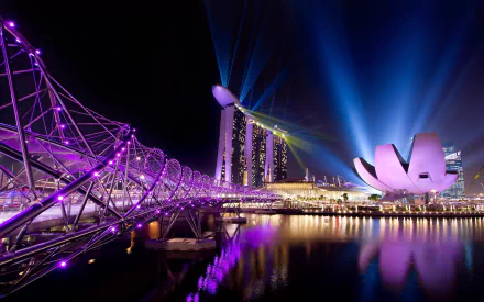 HD desktop wallpaper of Singapore's illuminated Helix Bridge and man-made Marina Bay Sands skyline at night, purple-lit walkway and ArtScience Museum reflecting on Marina Bay.