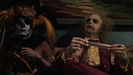 HD PC desktop wallpaper featuring a scene from the movie Beetlejuice, showing two characters in distinctive costumes and makeup against a dark backdrop.