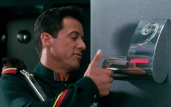 HD PC desktop wallpaper featuring a scene from the movie Demolition Man, showing a man in a uniform interacting with a futuristic device on a gray wall.