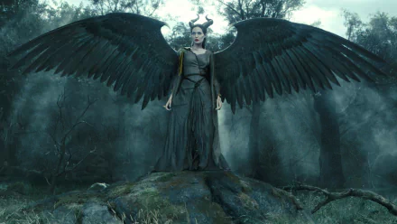 A stunning HD wallpaper featuring Angelina Jolie as Maleficent, showcasing her powerful presence with majestic wings in a dark, enchanted forest setting.