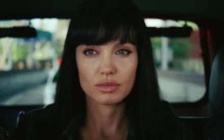 HD desktop wallpaper featuring Angelina Jolie as the lead character from the movie Salt, with a focused expression inside a vehicle.