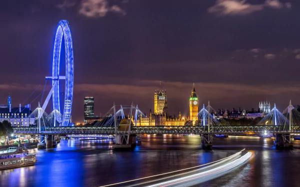 A stunning HD wallpaper featuring Big Ben and the London Eye illuminated at night, with the River Thames and city lights creating a vibrant urban scene.