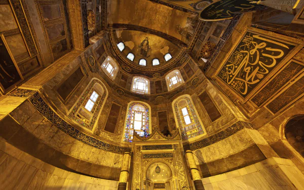 An HD wallpaper showcasing the stunning interior of Hagia Sophia, featuring intricate architecture, ornate decorations, and captivating stained glass windows.