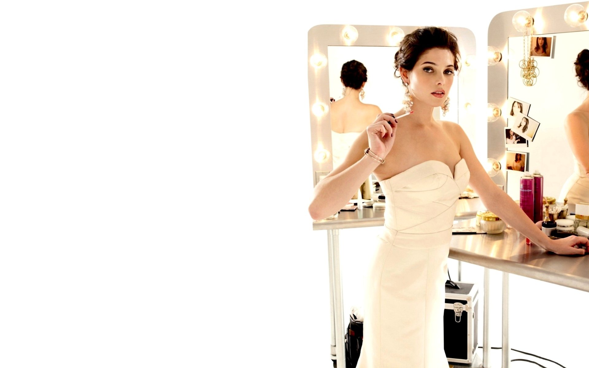 HD desktop wallpaper of celebrity Ashley Greene wearing an elegant white dress, standing by a vanity mirror with lights.