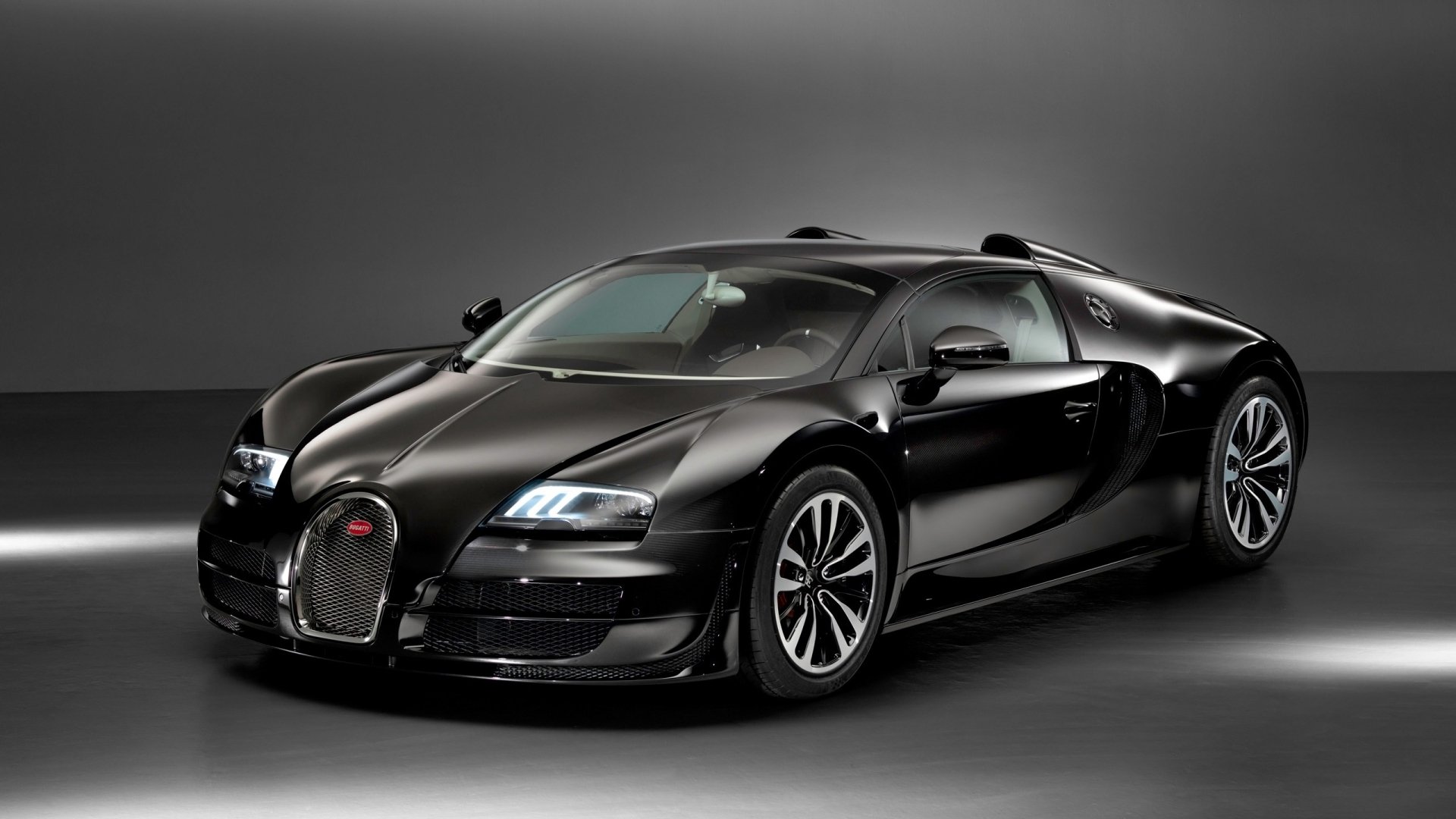 A sleek Bugatti Veyron Grand Sport Vitesse in a striking black finish, captured in high definition for an impressive desktop wallpaper or background.