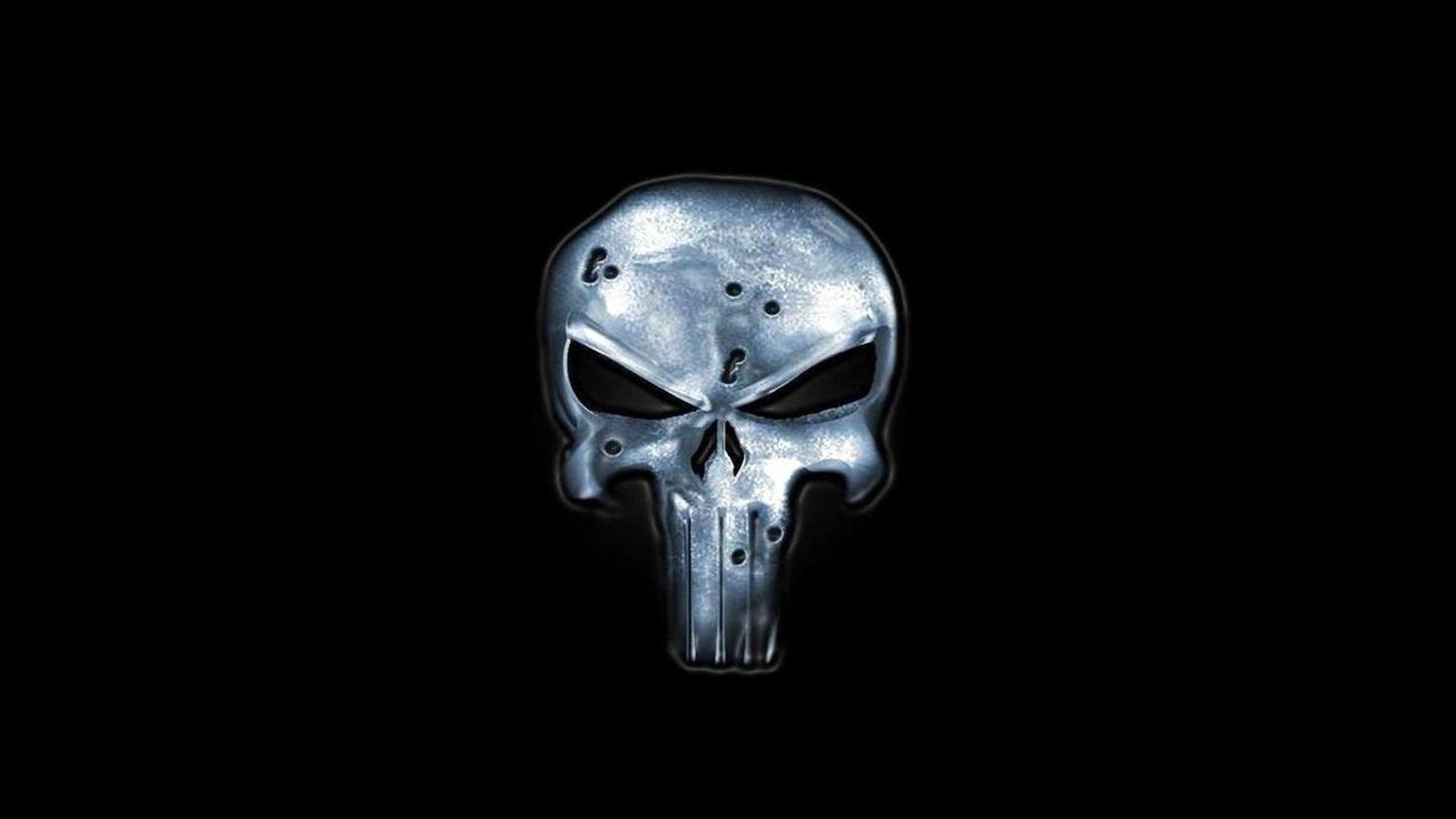 A bold HD desktop wallpaper featuring the iconic skull emblem associated with the Punisher comic, set against a stark black background.