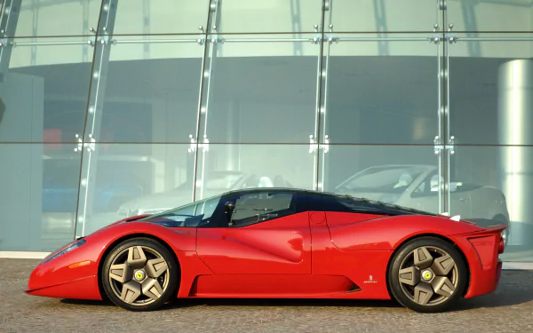 Red Ferrari Pininfarina P4/5 concept vehicle parked before a glass facade, rendered as an HD PC desktop wallpaper background.