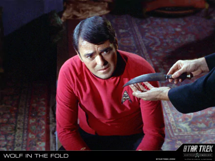 HD PC desktop wallpaper/background from the TV show Star Trek: The Original Series — a red‑shirted crew member kneels as a hand presents a knife.