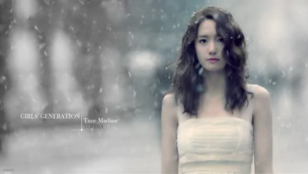 HD PC desktop wallpaper: a K-pop music idol from a girl group stands in falling snow with a soft-focus winter background, calm and ethereal portrait.
